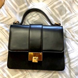 Black mini carry purse with gold accents